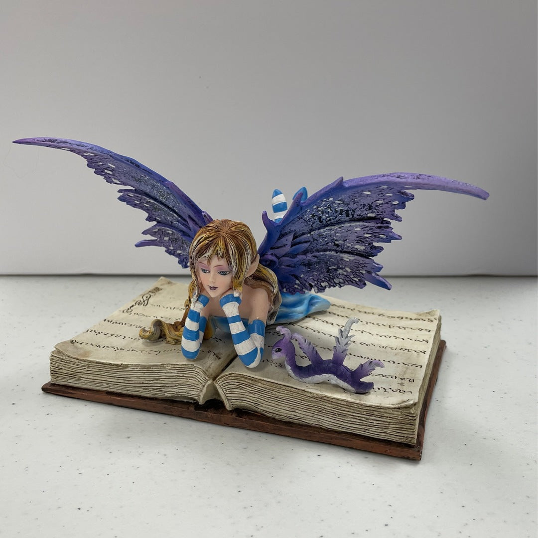 Fairy on Open Book with Worm Statue