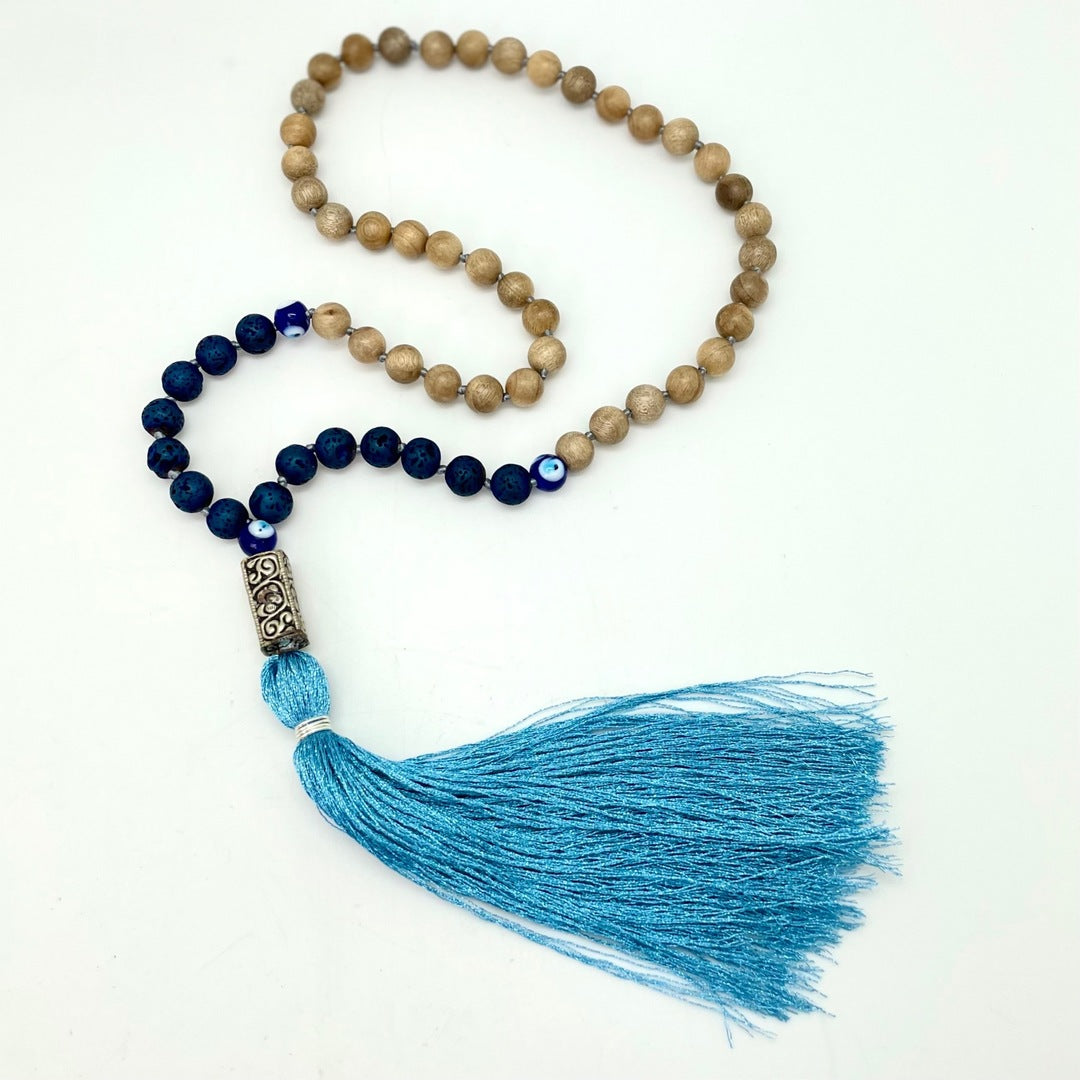 Handmade Mala - Sandalwood, Evil Eye, Titanium Basalt, Silver Charm (Metallic Blue Tassel)